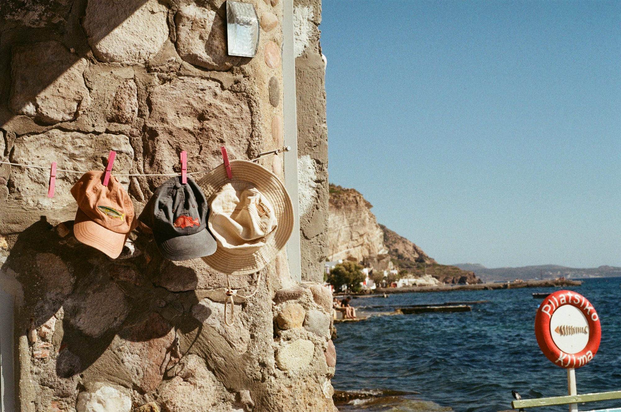 Pallion Point lids hanging no a line in Klima, Milos, Greece
